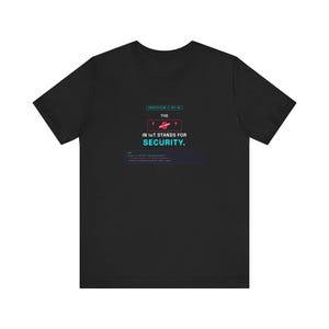 May include: A black short-sleeve t-shirt featuring a graphic with the text "SPECIFICATION // RFC-494", "THE", a red crossed-out "IoT" symbol, "IN IOT STANDS FOR SECURITY.", and a dark blue code block containing technical text.
