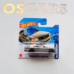 HotWheels ‘89 Mercedes-Benz 560 Sec AMG grey die cast car.