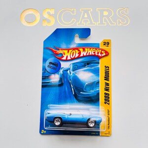 May include: A blue Hot Wheels die-cast toy car of a '70 Pontiac GTO model. The car is in its original packaging, which features the Hot Wheels logo and the text "2008 New Models". The packaging also includes the text "OSCARS".