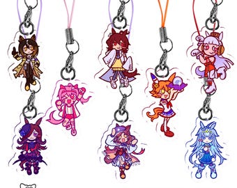 May include: A collection of eight acrylic mini charms featuring colourful anime-style character illustrations. Each charm is attached to a thin coloured cord with a metal lobster clasp. The text 1 Inch Mini Charms is printed at the bottom.