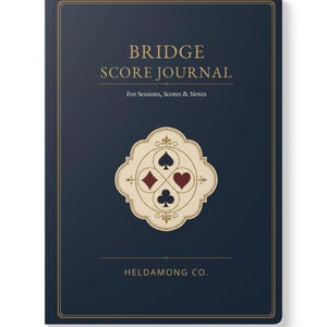 May include: A dark blue journal with gold text reading BRIDGE SCORE JOURNAL For Sessions, Scores & Notes and HELDAMONG CO. at the bottom. The centre features a cream-coloured decorative emblem containing the four card suit symbols in black and red.
