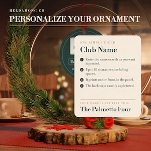 May include: A circular ornament display featuring a green pine branch, a wood slice base, and a white instructional card titled Personalize Your Ornament. The card includes text fields for Club Name and shows an example name, The Palmetto Four.