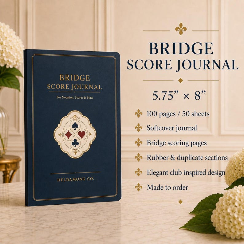 May include: A dark blue softcover Bridge Score Journal measuring 14.6 cm by 20.3 cm. The cover features gold text, a central emblem with four card suit symbols, and the brand name HELDAMONG CO. The journal contains 100 pages for notation and scores.