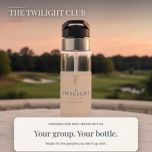 May include: A clear water bottle with a black lid and a straw, featuring a beige label with the text THE TWILIGHT CLUB, a TC logo, and the phrase FOR THE SOCIAL GAME. The bottle is positioned against a blurred outdoor golf course background.