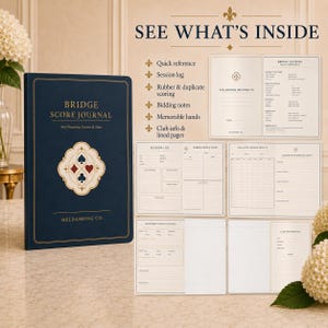 May include: A dark blue Bridge Score Journal featuring gold text and a central card suit emblem. The journal is presented with open pages displaying sections for quick reference, session logs, rubber and duplicate scoring, bidding notes, and club info.