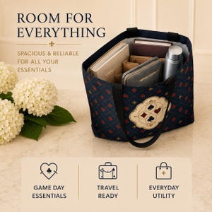 May include: A dark blue tote bag with a repeating pattern of red and black card suit symbols. The bag features a central emblem with four card suits, black handles, and internal compartments containing books, a wallet, and a silver metal bottle.