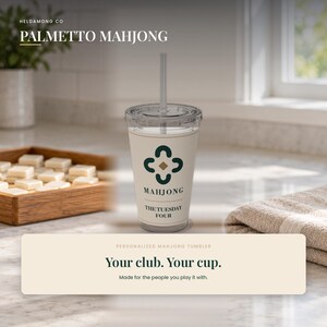 May include: A clear plastic tumbler with a straw, featuring a cream-colored wrap with a dark green four-part floral icon, a central brown diamond, and the text "MAHJONG" followed by "THE TUESDAY FOUR" printed in a dark serif font.