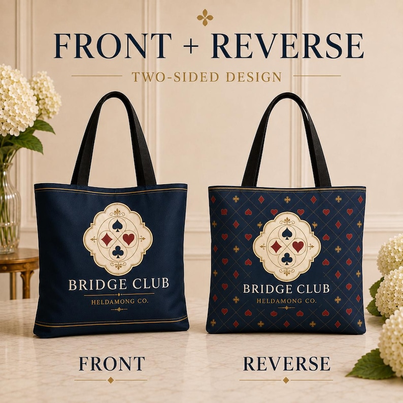 May include: Two navy blue tote bags with black handles. The front bag features a central cream-colored emblem with four card suit symbols and the text BRIDGE CLUB HELDAMONG CO. The reverse bag displays the same emblem over a repeating diamond pattern.