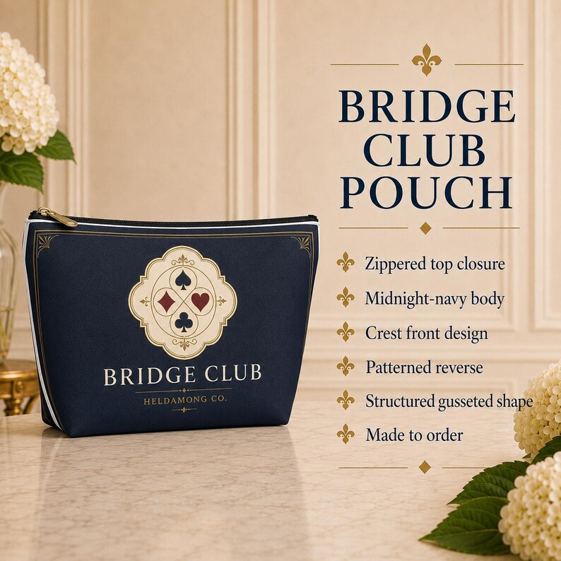 May include: A midnight-navy zippered pouch featuring a cream-colored crest with four card suit symbols and the text BRIDGE CLUB HELDAMONG CO. The structured, gusseted pouch has a white piped edge and a patterned reverse side for a classic look.