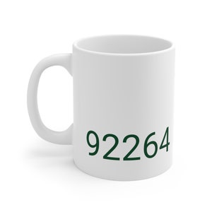 May include: White ceramic mug with a green 92264 printed on the front.