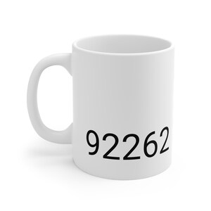 May include: White ceramic mug with the number 92262 printed in black on the front.