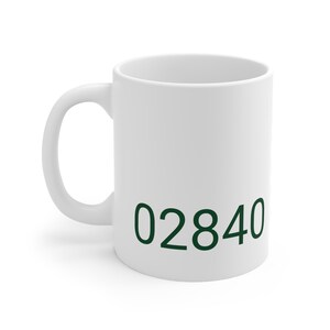 May include: White ceramic mug with a green 02840 printed on the front.