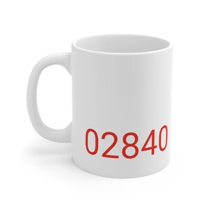 May include: White ceramic mug with the number "02840" printed in red on the front.