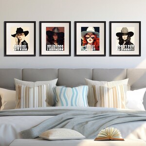 May include: Four framed art prints featuring stylized portraits of women wearing hats. Each print has a black frame and a white background. The prints have the words "COWGIRL", "FEARLESS", "LOYAL", and "RESILIENT" in bold, black text.