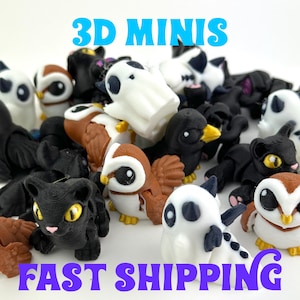 May include: A collection of 3D-printed mini figurines, including owls, cats, and ghosts. The figurines are in various colors, including black, white, and brown. Text in the image reads "3D MINIS" and "FAST SHIPPING".