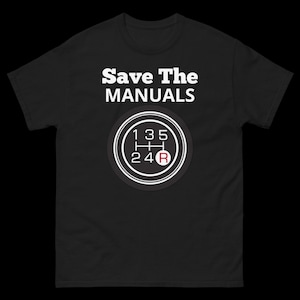 May include: Black t-shirt with white text that reads "Save The MANUALS" and a white graphic of a 5-speed manual transmission gear shift pattern with a red "R" for reverse.