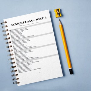 May include: A spiral-bound notebook with "LESSON PLANS - WEEK 3" printed on the cover. A yellow pencil and sharpener are next to the notebook on a light blue surface. The notebook's pages contain a list of daily tasks.
