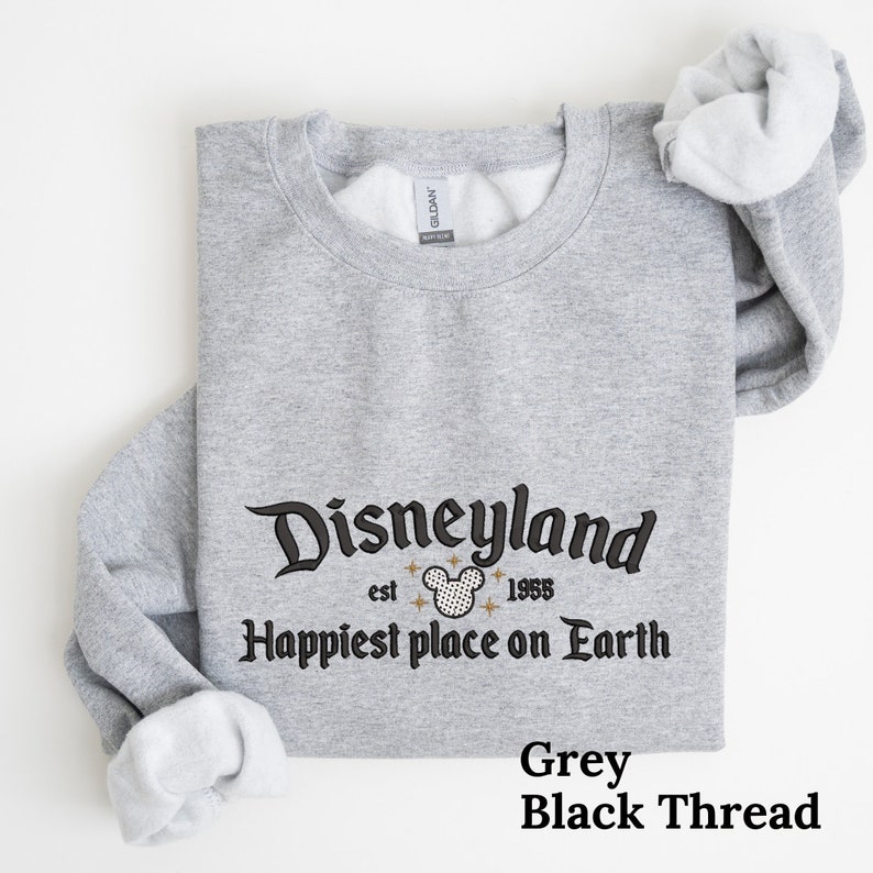 May include: Grey sweatshirt with black thread embroidery that reads "Disneyland est. 1955 Happiest place on Earth".