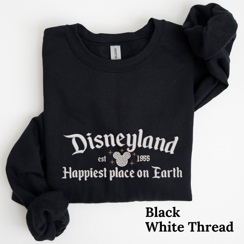 May include: Black sweatshirt with white thread embroidery that reads "Disneyland est 1955 Happiest place on Earth" with a Mickey Mouse head graphic.