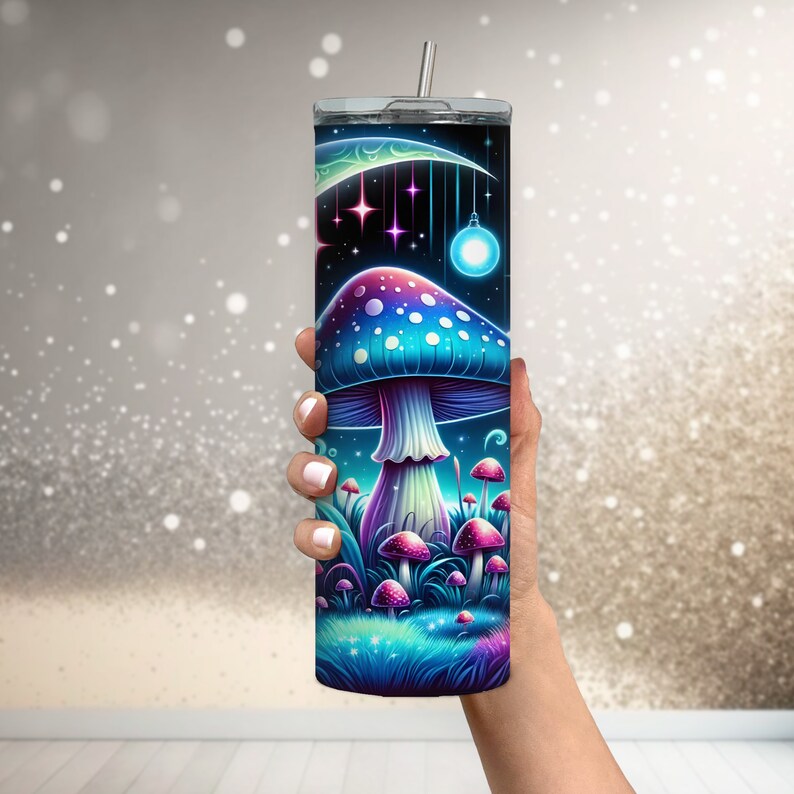 May include: A stainless steel tumbler with a colorful psychedelic mushroom design. The design features a large mushroom with blue and purple hues, surrounded by smaller mushrooms and a crescent moon with stars.