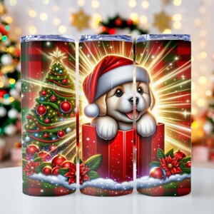 May include: Three stainless steel tumblers with Christmas-themed designs. The first tumbler features a green Christmas tree with red ornaments and lights. The second tumbler features a puppy wearing a Santa hat inside a red gift box. The third tumbler features a similar design to the first tumbler.