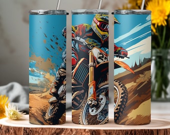 May include: Three stainless steel tumblers featuring a graphic of a motocross rider on a dirt bike. The rider is wearing a helmet and goggles. The background is a blue sky with clouds and a dirt track.