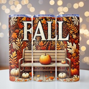 May include: Three stainless steel tumblers with a fall theme. The design features the word "FALL" in large white letters, a wooden bench, pumpkins, and autumn leaves in shades of orange, brown, and yellow. The background is a mix of fall foliage.