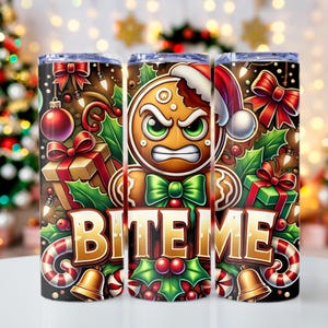 May include: A set of three stainless steel tumblers with a Christmas-themed design. Each tumbler features a gingerbread man with an angry expression, wearing a Santa hat and bow tie, surrounded by holly, gifts, and the text "BITE ME".