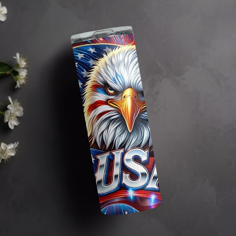 May include: A stainless steel tumbler with a patriotic design featuring a bald eagle with red, white, and blue feathers, and the word "USA" in a metallic font.