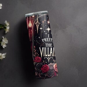 May include: A black and gold stainless steel tumbler with a dark background and a floral design. The tumbler features the text "I prefer the villain".