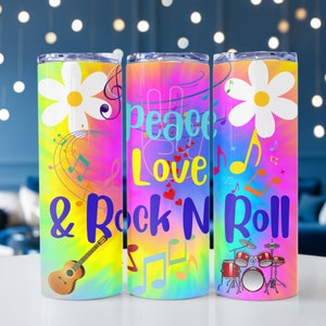 May include: Three colorful stainless steel tumblers with a tie-dye background. The tumblers feature a daisy, peace sign, and drum set with the text "Peace Love & Rock N Roll" in a rainbow font.