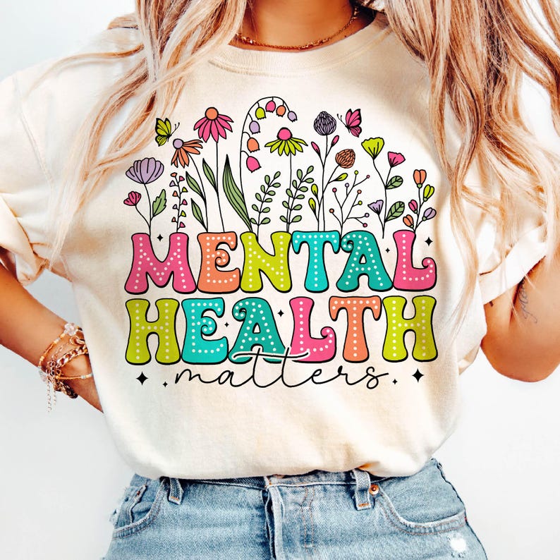 May include: A white t-shirt with a colorful graphic design featuring flowers and the text "MENTAL HEALTH matters".
