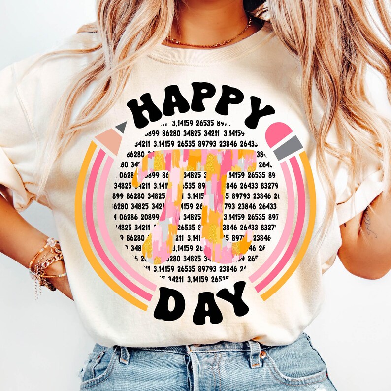 May include: A white t-shirt with a colorful graphic design that says "HAPPY DAY" in a retro font. The graphic features a rainbow with a pencil and numbers around it.
