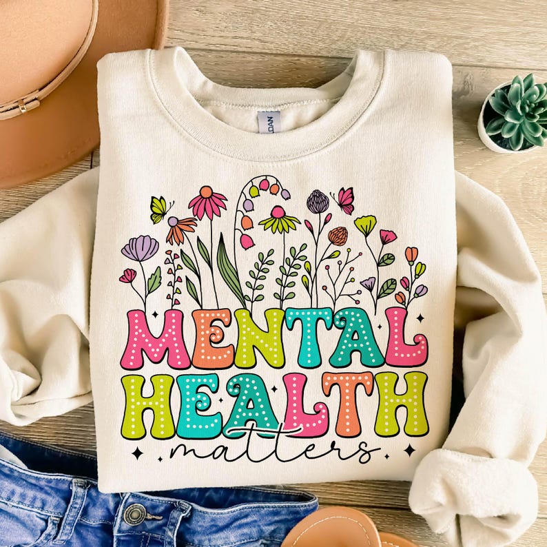 May include: A white sweatshirt with a colorful floral design and the text "Mental Health matters".