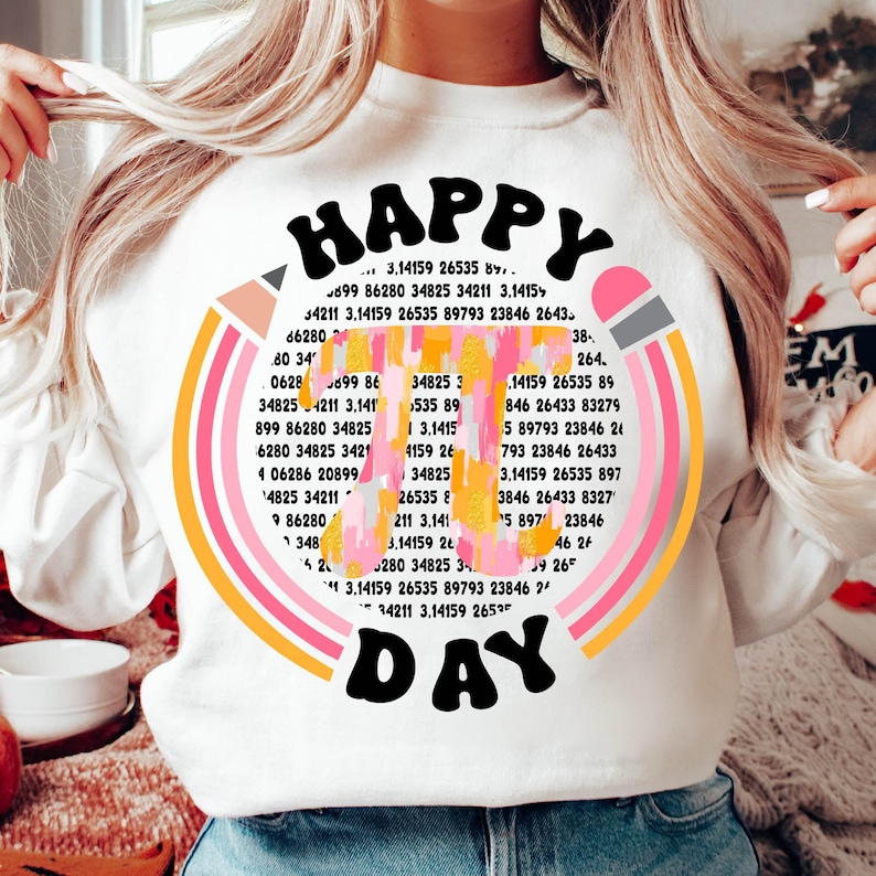 May include: A white sweatshirt with a colorful graphic design that says "HAPPY DAY" in a retro font. The graphic includes a pencil, rainbow stripes, and a series of numbers.