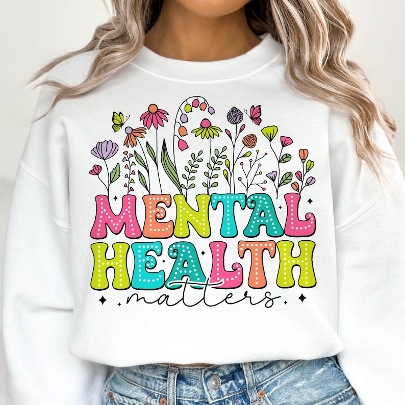 May include: White sweatshirt with a colorful floral design and the text "MENTAL HEALTH matters".