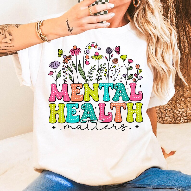 May include: White t-shirt with a colorful floral design and the text "MENTAL HEALTH matters".