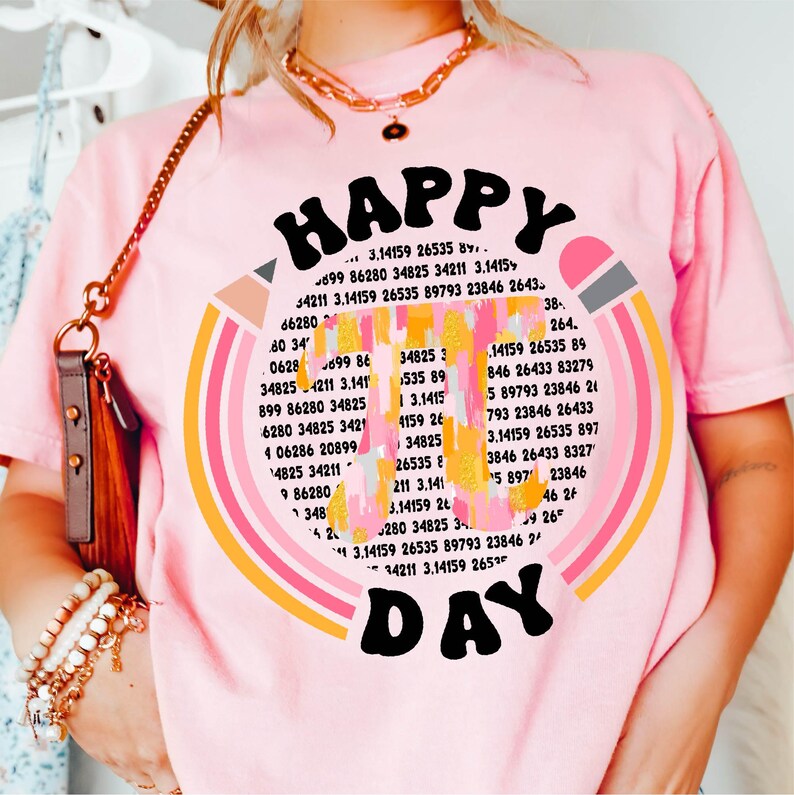 May include: Pink t-shirt with a rainbow design and the text "HAPPY DAY" in a retro font. The rainbow is made up of colorful stripes with numbers and mathematical symbols inside each stripe.