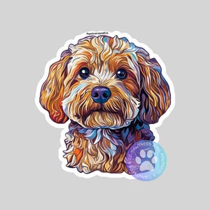 May include: A sticker featuring a colorful illustration of a dog's face. The dog has brown, orange, and white fur, with a purple nose and big blue eyes. The sticker has a white border and the text "PawternsandCo." is visible.