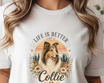 May include: White t-shirt featuring a Collie dog illustration within a circular design. The design includes the text "Life is better with a Collie" in a decorative font, surrounded by floral and mountain elements.