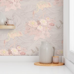 May include: A kitchen countertop with a light gray ceramic pitcher and a small brown ceramic jar on a wooden tray. The background is a pink and gray wallpaper with a floral and wave pattern.