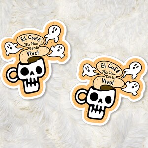 May include: Two orange and white stickers with a skull-shaped coffee mug and the text "El Cafe Me Hace Sentir Vivo!" surrounded by four white ghosts.