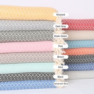 May include: A stack of patterned woven throws in various colors, including mustard, dark gray, khaki green, pink, brown, mint, black, parliament blue, red, light beige, turquoise, orange, navy blue, sax blue, and light blue.