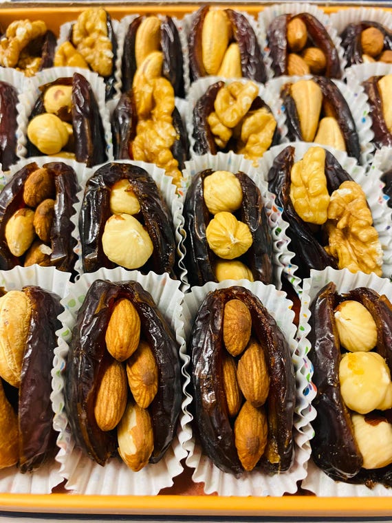 Individually wrapped Palestinian Medjool dates Gift Box: Stuffed with Nuts, Almonds, hazelnuts, walnuts, cashews, 24 pieces.