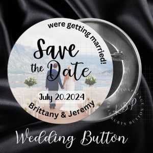 May include: A round, silver wedding button with a white background and a photo of a couple getting married. The text "Save the Date" is written in black cursive font. The date "July 20, 2024" and the names "Brittany & Jeremy" are also written in black font.