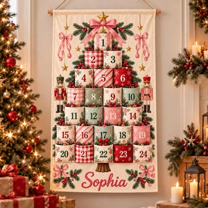 May include: A hanging fabric advent calendar featuring a Christmas tree design with twenty-four numbered pockets in red, green, and white patterns. The tree is decorated with nutcrackers, bows, and the name Sophia printed in red script at the bottom.