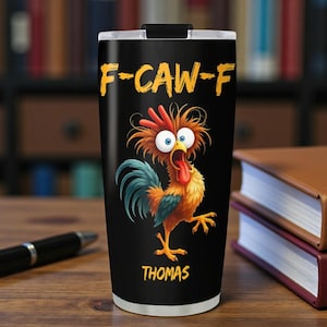 May include: Black stainless steel tumbler with a cartoon rooster illustration. The rooster has a red comb, blue eyes, and a long red tongue. The text "F-CAW-F" and the name "THOMAS" are printed in yellow.