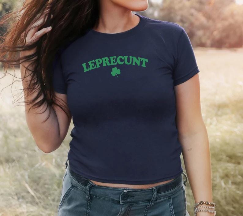 May include: A navy blue t-shirt with the text "LEPRECUnt" in green letters and a green shamrock.