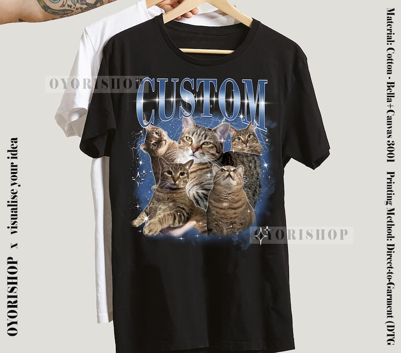 May include: Black t-shirt with a graphic print of a group of cats in a galaxy-like background. The text "CUSTOM" is printed in white letters above the cats.