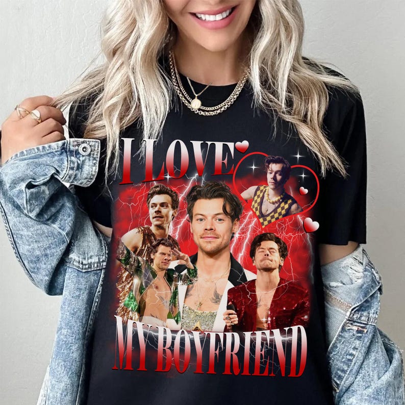 Op de afbeelding: Zwart T-shirt met een collage van afbeeldingen van een man met de tekst "I LOVE MY BOYFRIEND" in rood en wit.